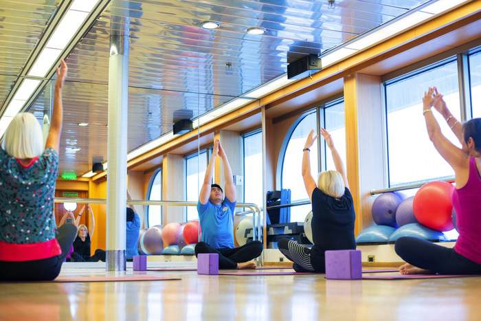 Fred. Olsen Cruise Lines Guests doing yoga pilates class in fitness centre.jpg